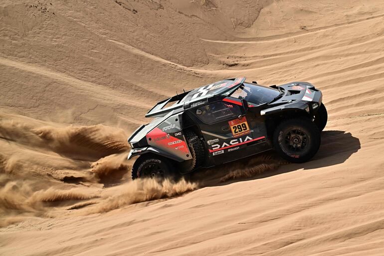 Vista de un rally del Dakar con vehículos recorriendo un terreno desértico.
